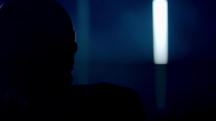 CU Portrait of American football player in protective uniform posing against bright flashing lights. Shot on ARRI Alexa Mini 60 FPS slow motion