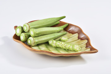 okra and sliced okra on the plate at the white background