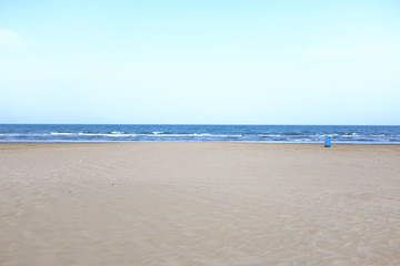 Spain, Valencia - Minimalist view of an empty sandy beach and calm Mediterranean sea horizon.