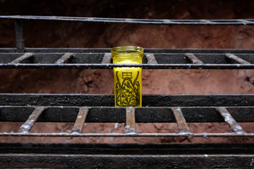 Montserrat, Spain - April 26: Detail of a yellow candle in a holder in a monastery in the province...