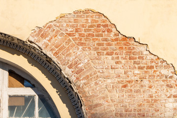 Restored wall with window of a vintage building, background