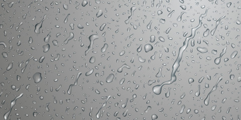 Background with drops and streaks of water in gray colors, flowing down the surface