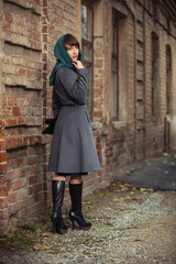 Fototapeta na wymiar Young fashion woman in gray classic coat and head scarf