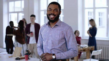 Portrait of young confident black successful male manager in formal clothes looking at camera...