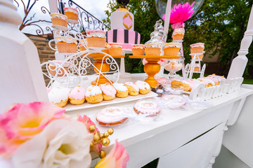 Candy Bar. White decorated wooden trolley with sweets close-up