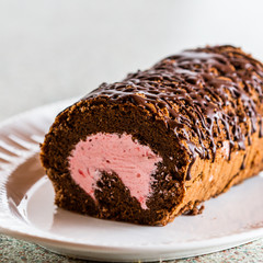 Chocolate log cake rolled with strawberry mouse