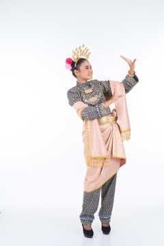 A beautiful Malaysian traditional female dancer performing the dance steps of a cultural dance routine called Tarian Inang in a traditional dance outfit. Full length isolated in white.