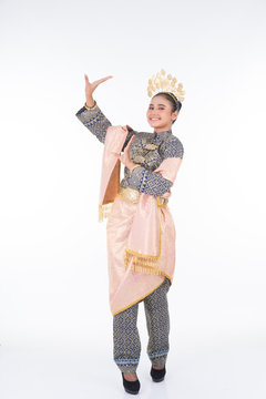 A beautiful Malaysian traditional female dancer performing the dance steps of a cultural dance routine called Tarian Inang in a traditional dance outfit. Full length isolated in white.
