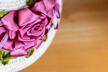 Close-up of artificial roses made from pink ribbons.