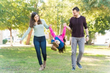 Happy Family Having Fun At Park During Weekend