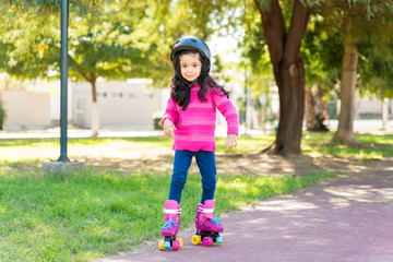 Fototapeta premium Girl Learning To Skate On Sidewalk