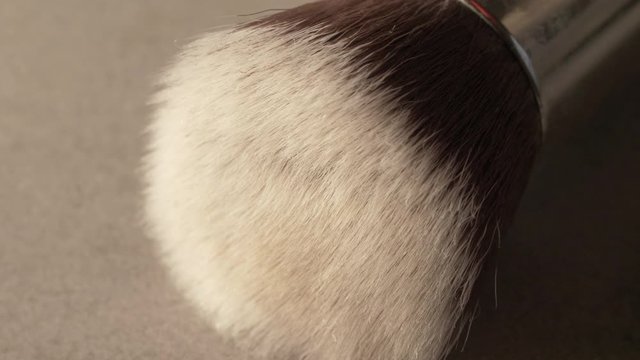 a make up brush on a concrete table closeup macro, in 4k 60p 10bit Apple ProRes422, with an external atomos recorder