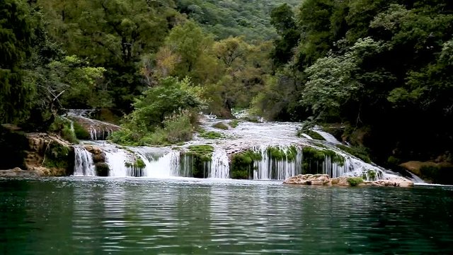 scenic view spectacular waterfall,boats in Los Micos, National Park in San Luis Potosi, Mexico