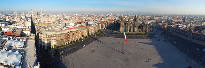 Mexico National Flag on Zocalo Constitution Square and Metropolitan Cathedral panorama aerial view, Mexico City CDMX, Mexico. Historic center of Mexico City is a UNESCO World Heritage Site since 1987.