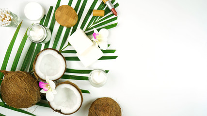 Coconut cosmetics theme flat lay creative layout overhead with pro environment alternative plastic free soaps, moisturizers and beauty products. Negative copy space.