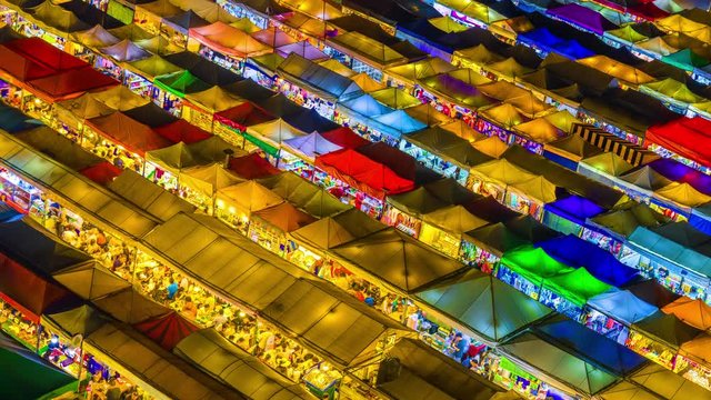 Time lapse of Train night market Ratchada Thailand Is a tourist attraction, eating and shopping for tourists From an aerial perspective, the roof is colorful and beautiful