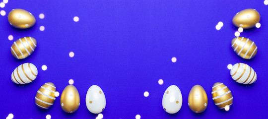 Easter basket with golden shine decorated eggs isolated on blue background. for you poster or flyer.