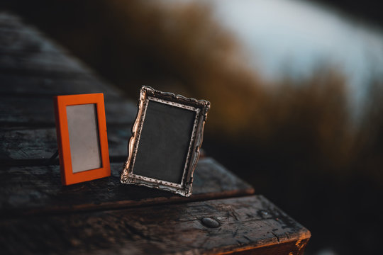 Empty photo frames on the table outside.