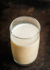 Banana milkshake with on the rustic background. Selective focus.