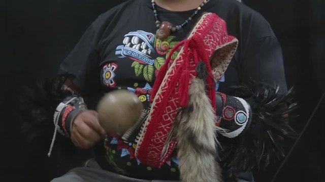 group of shaman Teotihuacanos, Xicalanca - Toltec in black background, with traditional dress dance with a trappings with feathers and drum