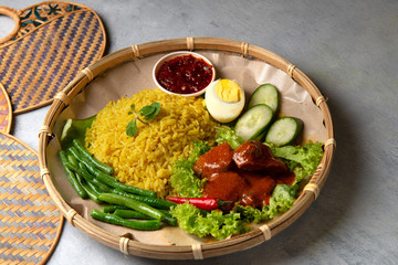 Turmeric rice with curry or nasi kunyit kuning, popular dish in malaysia