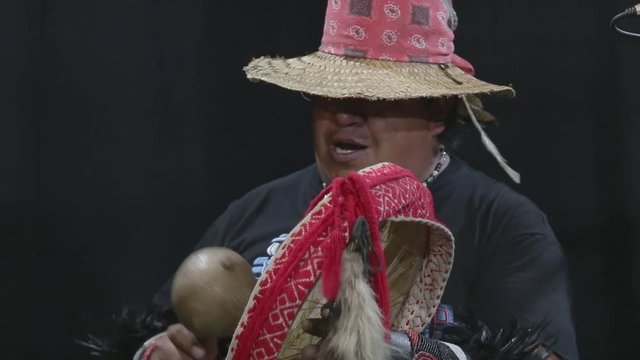 group of shaman Teotihuacanos, Xicalanca - Toltec in black background, with traditional dress dance with a trappings with feathers and drum