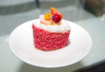 Mini colored sweet cakes on white plate. Delicious Dessert