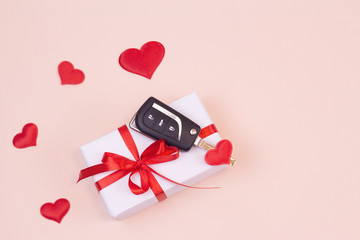 Gift box and car keys with remote control. Valentine's day, birthday. Copy space for text.