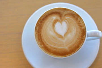hot latte coffee drink put on wooden table in cafe restaurant