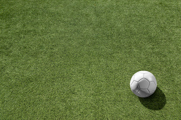 Top view white soccer ball with line on soccer field background.