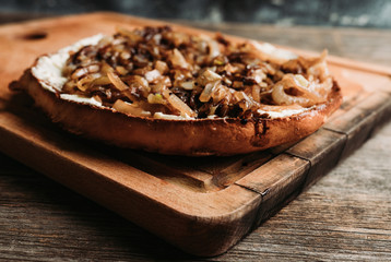 Homemade pizza with goat cheese, caramelized onion and balsamic vinegar. Selective focus. Shallow depth of field.