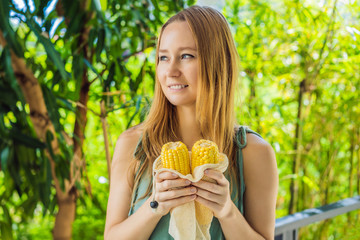 Corn in a reusable bag in the hands of a young woman. Zero waste concept