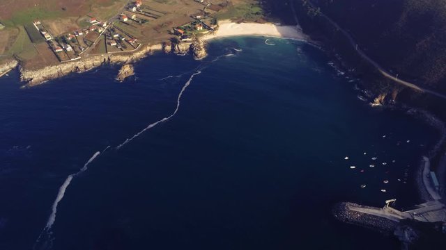 The beautiful blue waters of the Praia de Barizo in Spain - aerial zoom
