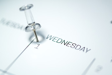 White push pin on the 1st  date of the calendar Wednesday - 1st of April Wednesday - April fools day 2020