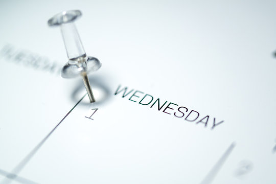 White push pin on the 1st  date of the calendar Wednesday - 1st of April Wednesday - April fools day 2020