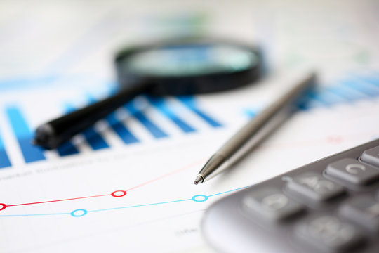 Financial statistics documents ball pen infographics at office table closeup. Internal Revenue Service inspector sum check, investigation, exchange market, earnings, savings, loan and credit concept
