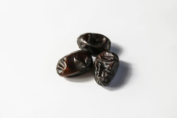 Dried dates fruits on white background