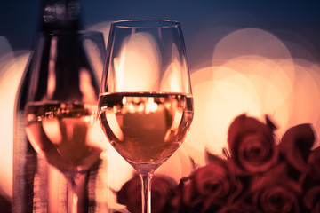 two glasses of champagne and red roses