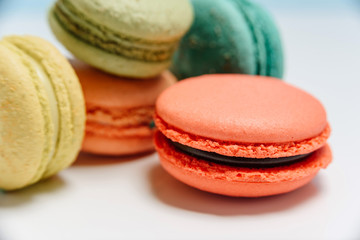 Bright multi-colored French macarons on a white background
