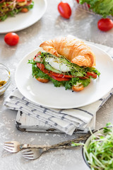 Croissant red fish and poached egg sandwich