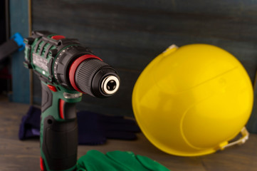 Obraz premium Cordless drill and yellow protective helmet