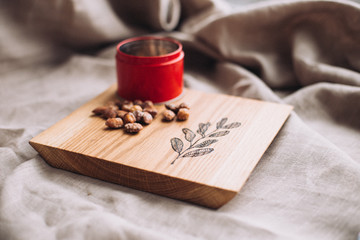 Wooden сutting board engraved with botanical pictures, wood board on linen surface 