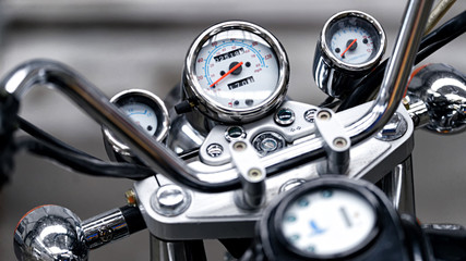 Retro motorcycle speedometer close-up with blurry background