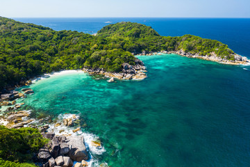 Aerial view drone shot ocean waves, Beautiful tropical beach and rocky coastline and beautiful forest. Nga Khin Nyo Gyee Island Myanmar. Tropical seas and islands in southern Myanmar