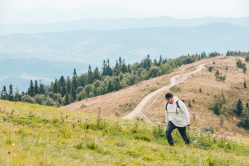 Fototapeta na wymiar man with backpack hiking in mountains