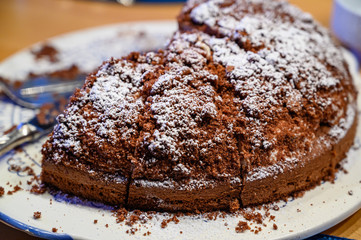 Chocolate cake with powdered sugar on a table