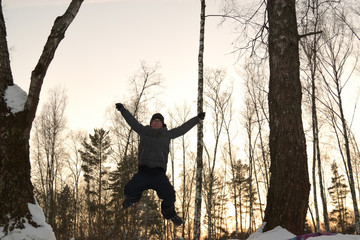 boy jumping from a mountain covered in snow. winter games outdoor