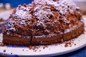 Chocolate cake with powdered sugar on a table
