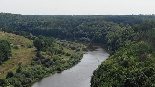Aerial View of A River Bordered by Thick Forest