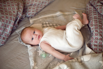 newborn baby is lying on the bed